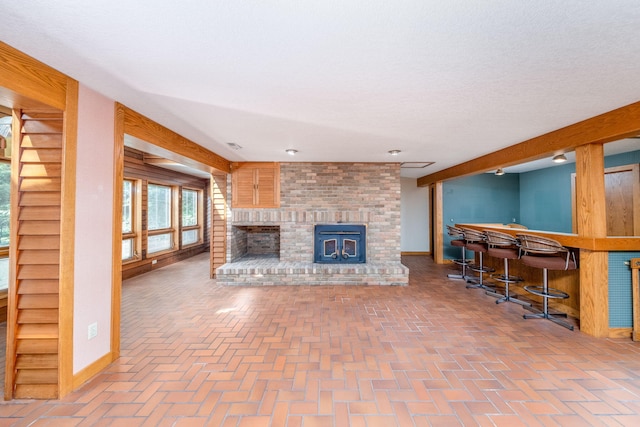 3075 Mineral Springs Trl, Mount Pleasant, MI 48858 - living room featuring a bar, brick flooring, and a brick fireplace