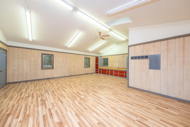 3075 Mineral Springs Trl, Mount Pleasant, MI 48858 - unfurnished room featuring light wood-style flooring, electric panel, wooden walls, lofted ceiling, and ceiling fan