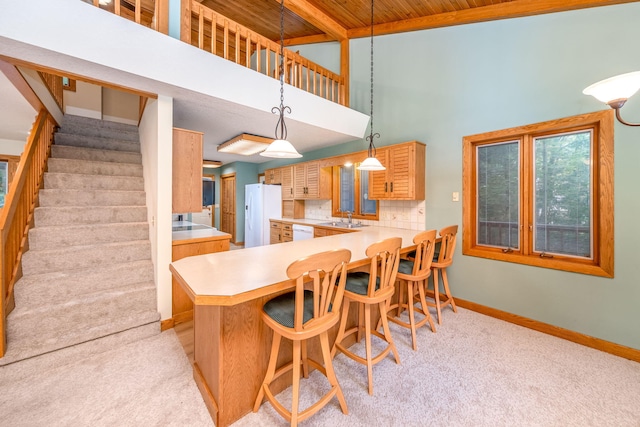 3075 Mineral Springs Trl, Mount Pleasant, MI 48858 - kitchen with white appliances, light carpet, light countertops, a peninsula, and wooden ceiling