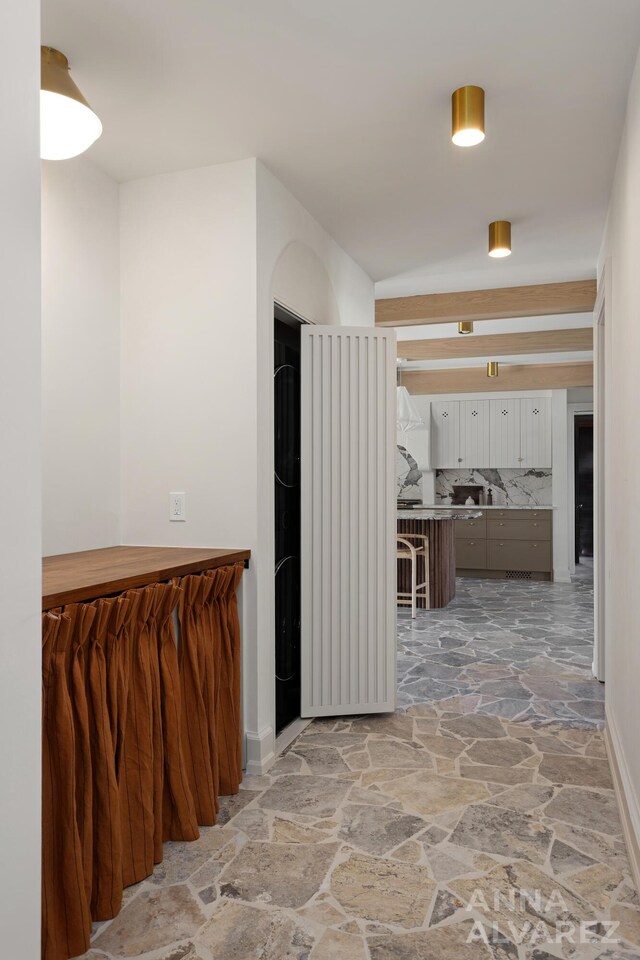 727 Plymouth Rd SE, East Grand Rapids, MI 49506 - hallway with stone floors and baseboards