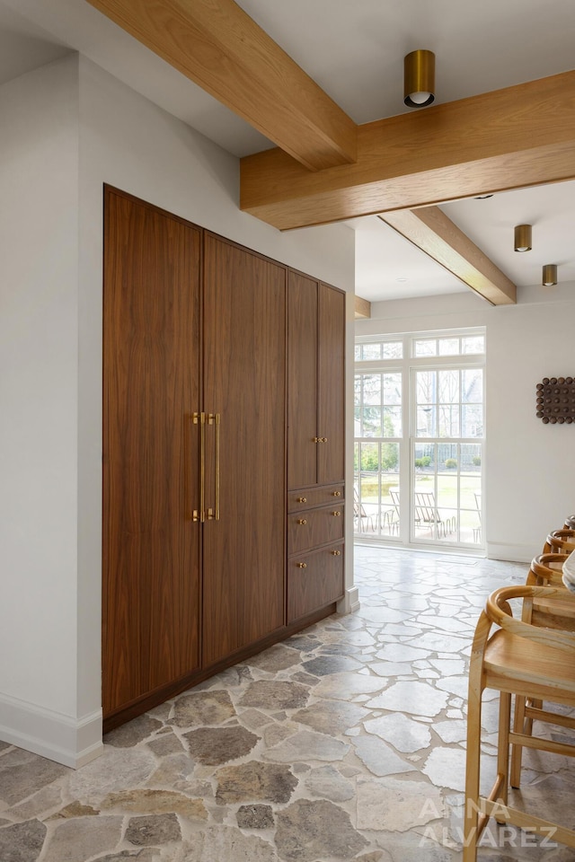 727 Plymouth Rd SE, East Grand Rapids, MI 49506 - foyer entrance featuring stone flooring and beamed ceiling