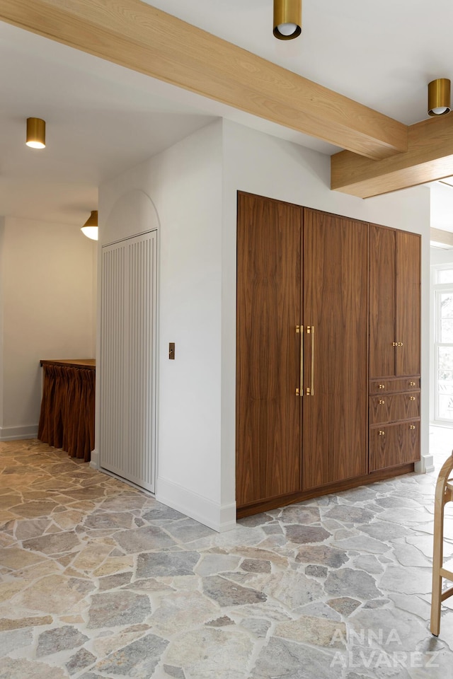727 Plymouth Rd SE, East Grand Rapids, MI 49506 - interior space with stone floors and beamed ceiling