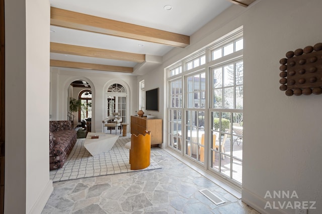 727 Plymouth Rd SE, East Grand Rapids, MI 49506 - sunroom featuring french doors, beam ceiling, arched walkways, and plenty of natural light
