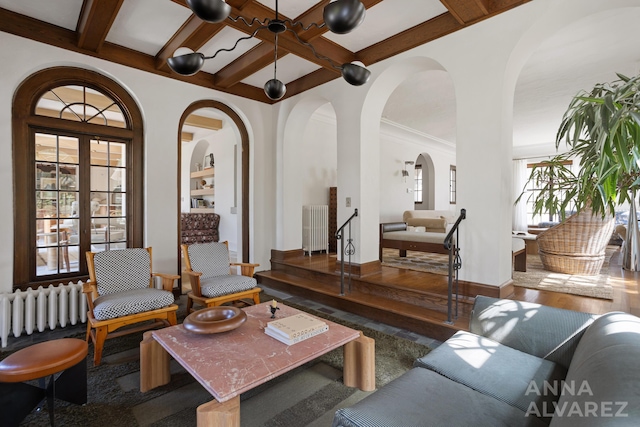 727 Plymouth Rd SE, East Grand Rapids, MI 49506 - living room with coffered ceiling, radiator, wood finished floors, beam ceiling, and arched walkways