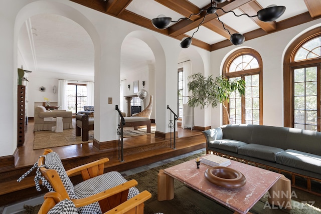 727 Plymouth Rd SE, East Grand Rapids, MI 49506 - living area with coffered ceiling, wood finished floors, arched walkways, and beam ceiling