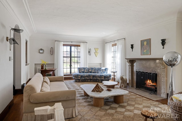 727 Plymouth Rd SE, East Grand Rapids, MI 49506 - living area featuring a high end fireplace, healthy amount of natural light, wood finished floors, crown molding, and a textured ceiling