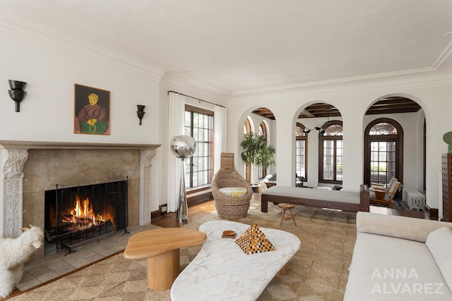 727 Plymouth Rd SE, East Grand Rapids, MI 49506 - tiled living room featuring a high end fireplace, crown molding, and arched walkways