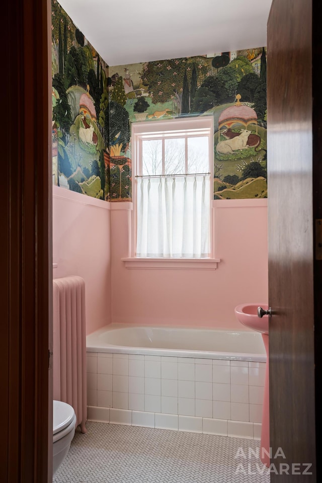 727 Plymouth Rd SE, East Grand Rapids, MI 49506 - bathroom featuring radiator and a relaxing tiled tub