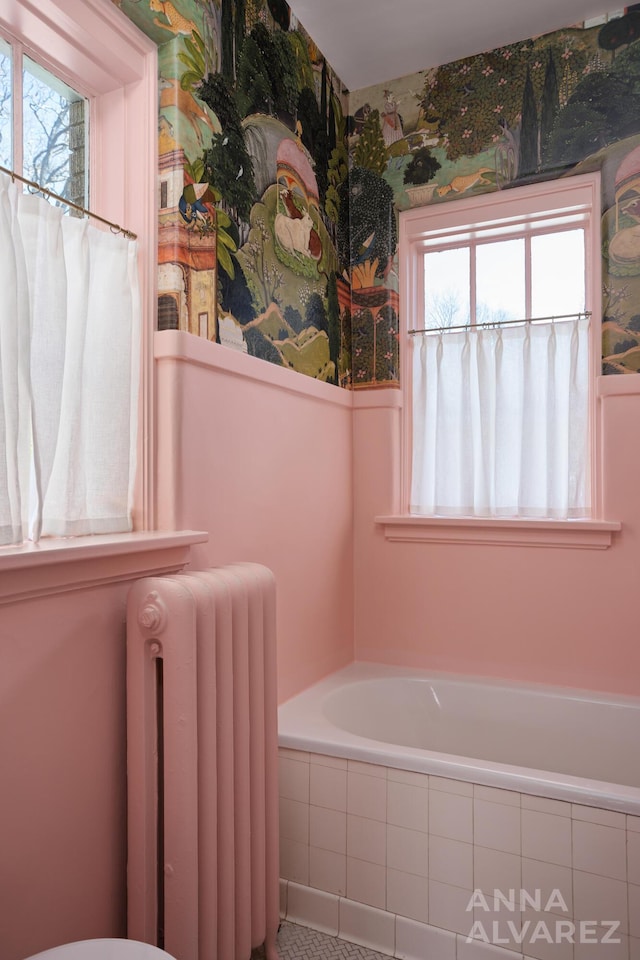 727 Plymouth Rd SE, East Grand Rapids, MI 49506 - bathroom featuring radiator heating unit, healthy amount of natural light, and a bath