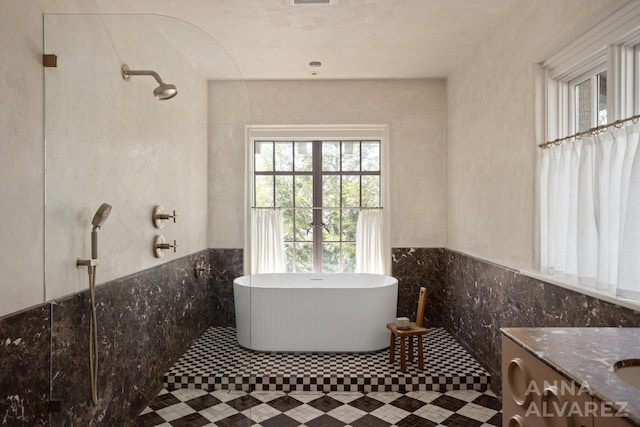 727 Plymouth Rd SE, East Grand Rapids, MI 49506 - full bath with a freestanding bath, tile walls, a shower, vanity, and wainscoting