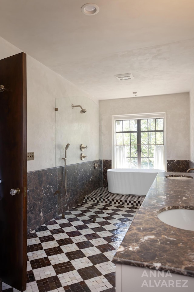 727 Plymouth Rd SE, East Grand Rapids, MI 49506 - bathroom featuring tiled shower, double vanity, and a freestanding tub