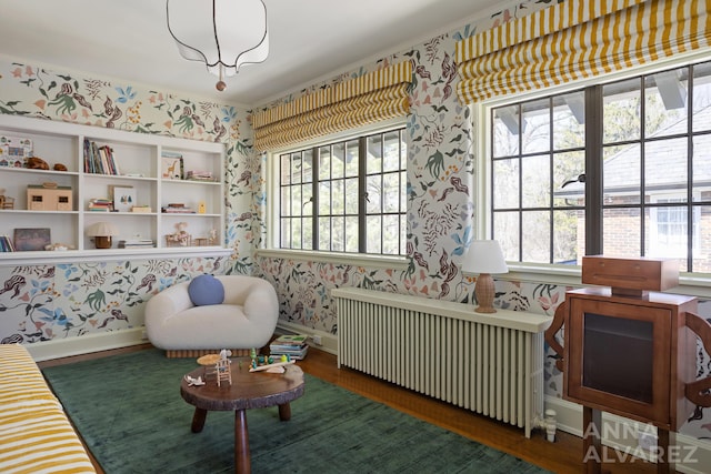727 Plymouth Rd SE, East Grand Rapids, MI 49506 - sitting room featuring radiator heating unit, wallpapered walls, and wood finished floors