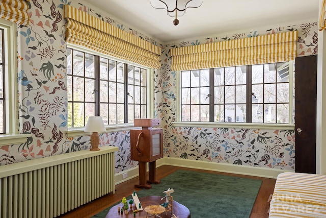 727 Plymouth Rd SE, East Grand Rapids, MI 49506 - sitting room with radiator, wallpapered walls, and wood finished floors