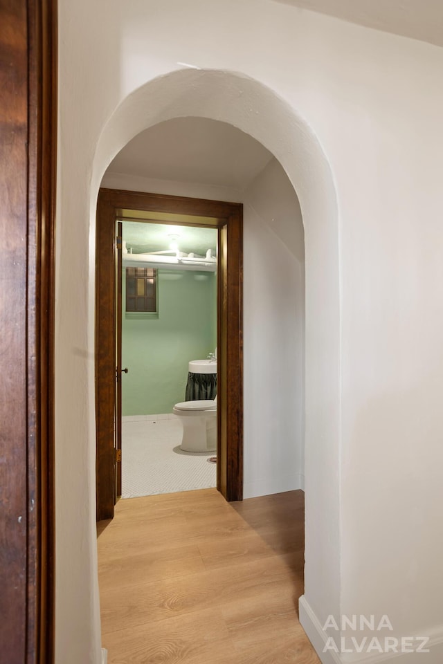 727 Plymouth Rd SE, East Grand Rapids, MI 49506 - hall featuring arched walkways and wood finished floors