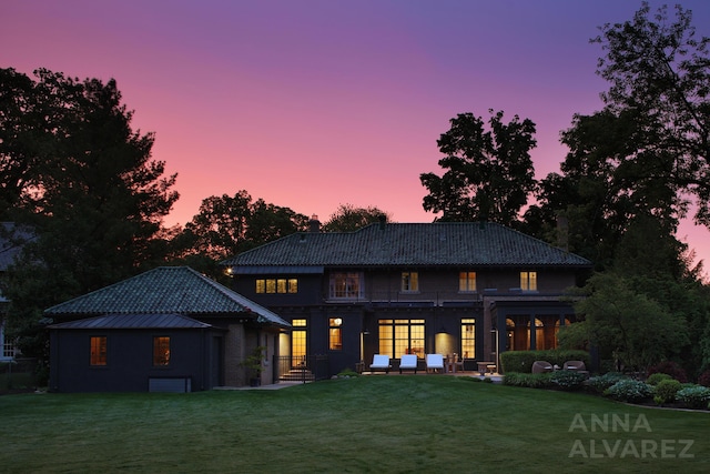 727 Plymouth Rd SE, East Grand Rapids, MI 49506 - back of house at dusk featuring a yard and a balcony
