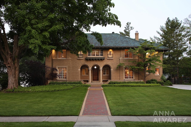 727 Plymouth Rd SE, East Grand Rapids, MI 49506 - mediterranean / spanish home with a chimney, a front lawn, and brick siding
