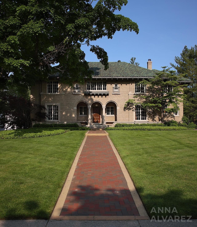 727 Plymouth Rd SE, East Grand Rapids, MI 49506 - view of front facade with a chimney and a front lawn