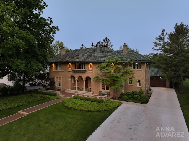 727 Plymouth Rd SE, East Grand Rapids, MI 49506 - mediterranean / spanish home featuring a chimney and a front yard