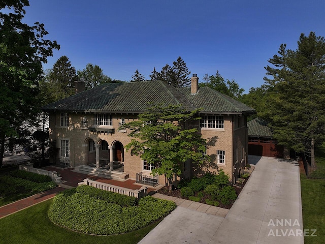 727 Plymouth Rd SE, East Grand Rapids, MI 49506 - view of front of home with a chimney and driveway