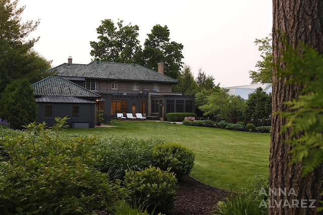 727 Plymouth Rd SE, East Grand Rapids, MI 49506 - view of grassy yard with a sunroom