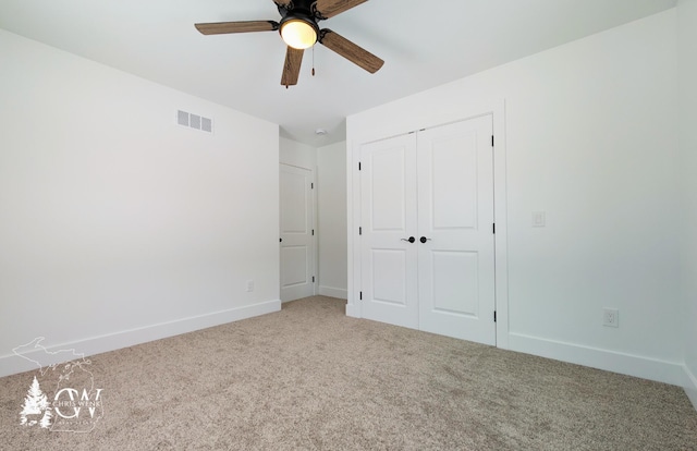 unfurnished bedroom featuring carpet, a closet, visible vents, a ceiling fan, and baseboards