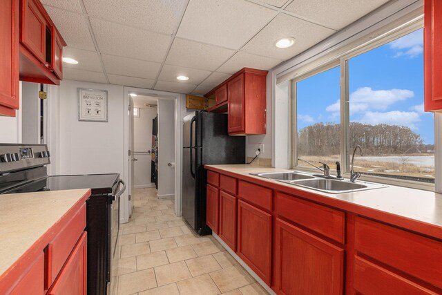 6665 E Lake St, Sand Lake, MI 49343 - kitchen featuring a sink, stainless steel electric stove, freestanding refrigerator, recessed lighting, and light countertops