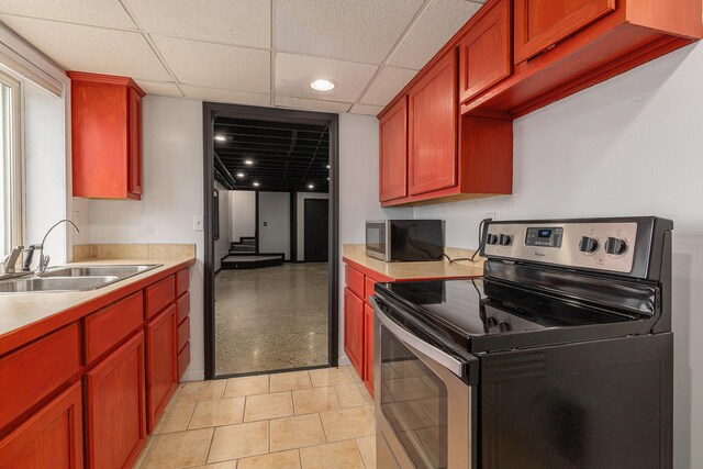 6665 E Lake St, Sand Lake, MI 49343 - kitchen with a drop ceiling, dark brown cabinets, a sink, light countertops, and appliances with stainless steel finishes