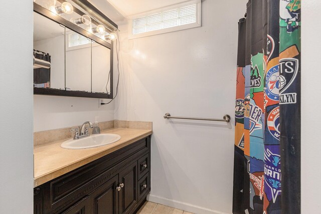 6665 E Lake St, Sand Lake, MI 49343 - bathroom with tile patterned floors, curtained shower, and vanity