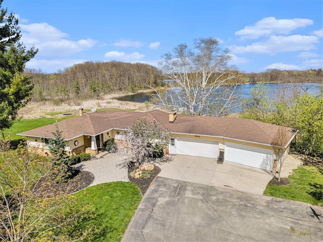 6665 E Lake St, Sand Lake, MI 49343 - view of front of home with concrete driveway, a water view, and a garage