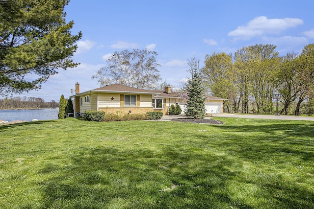 6665 E Lake St, Sand Lake, MI 49343 - ranch-style home with concrete driveway, an attached garage, a front lawn, and a chimney