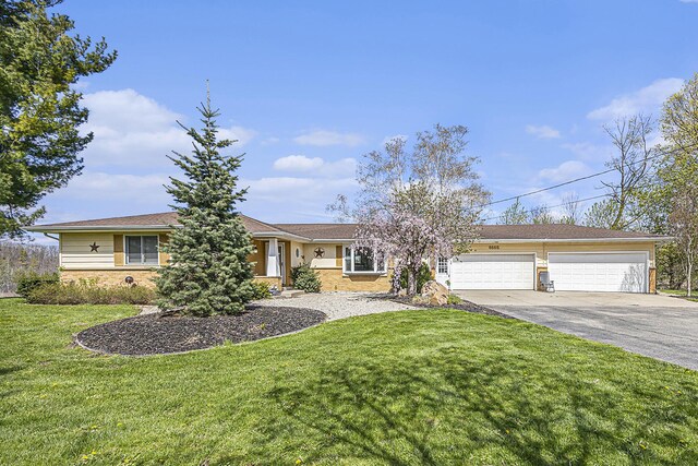 6665 E Lake St, Sand Lake, MI 49343 - view of front of home with a front yard, a garage, and driveway
