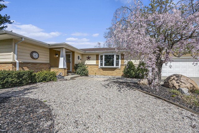 6665 E Lake St, Sand Lake, MI 49343 - single story home with driveway, brick siding, and an attached garage
