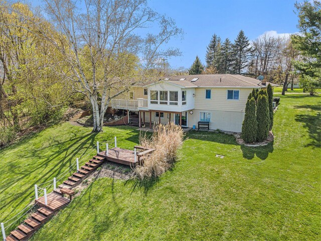 6665 E Lake St, Sand Lake, MI 49343 - back of property featuring a lawn, stairway, and a wooden deck