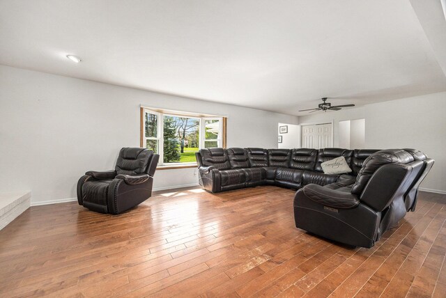 6665 E Lake St, Sand Lake, MI 49343 - living room featuring baseboards, a ceiling fan, and wood finished floors