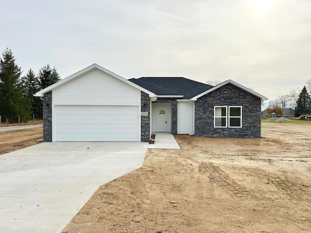 single story home with a garage and concrete driveway