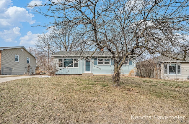 view of front of property with entry steps and a front lawn