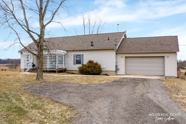 ranch-style house with dirt driveway, a shingled roof, and an attached garage