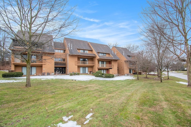 rear view of property with a yard