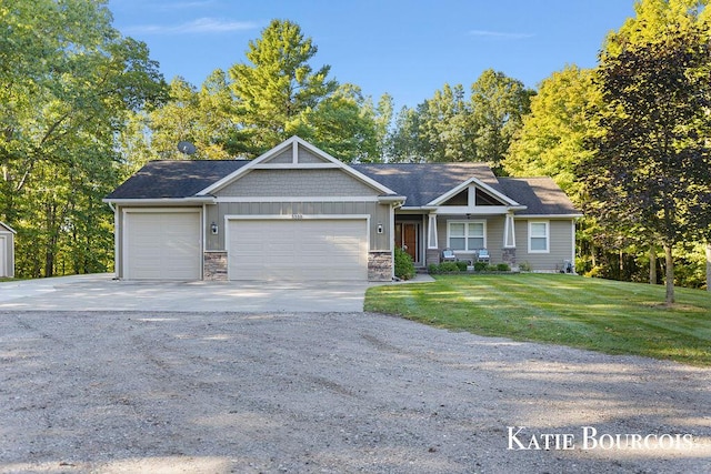 craftsman-style home with an attached garage, stone siding, driveway, a front lawn, and board and batten siding