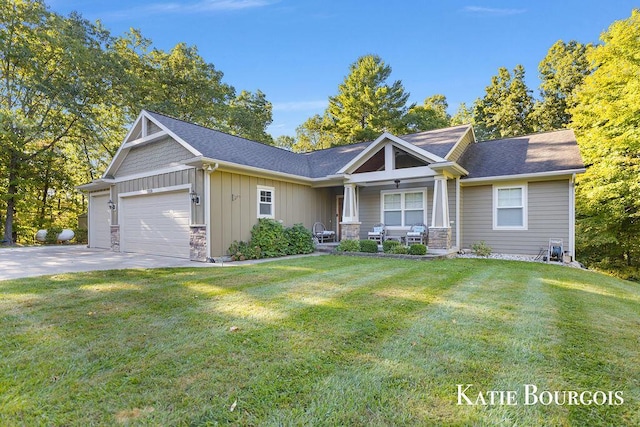 view of front facade with a garage, concrete driveway, stone siding, board and batten siding, and a front yard