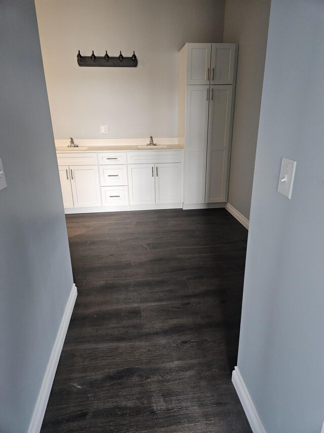 interior space featuring a sink and baseboards