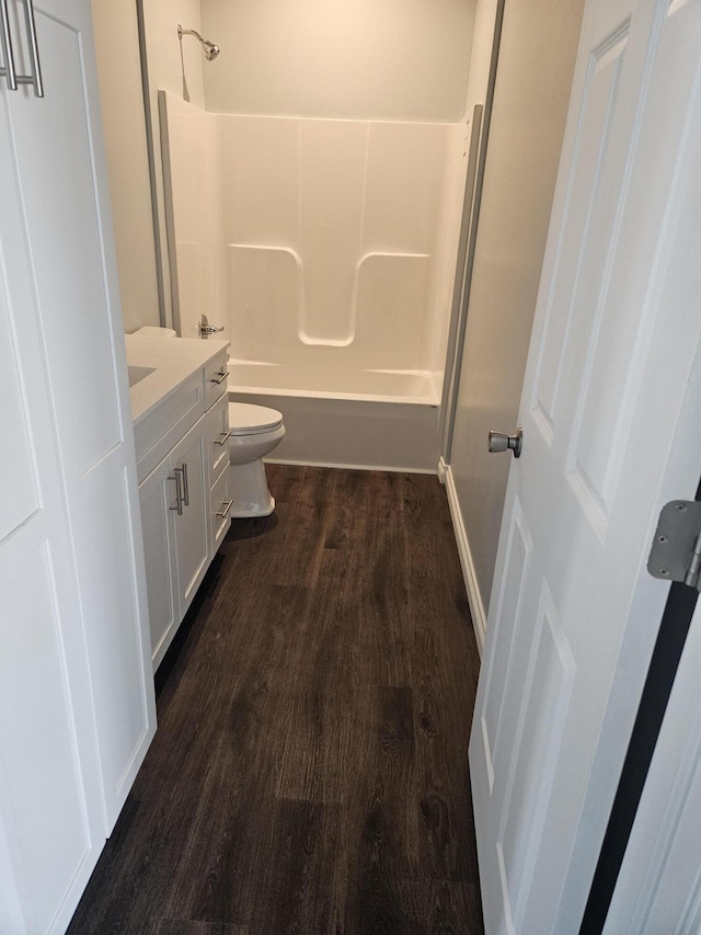 full bathroom featuring toilet, shower / tub combination, wood finished floors, and vanity