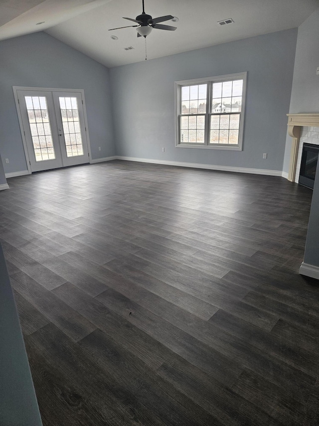 unfurnished living room featuring dark wood-style flooring, a ceiling fan, baseboards, french doors, and a glass covered fireplace