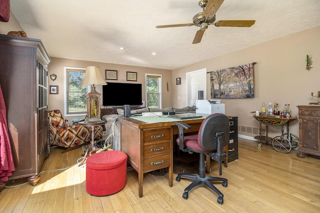 home office featuring wood-type flooring, baseboards, and a ceiling fan
