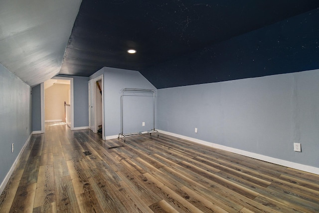 additional living space with lofted ceiling, baseboards, and wood finished floors