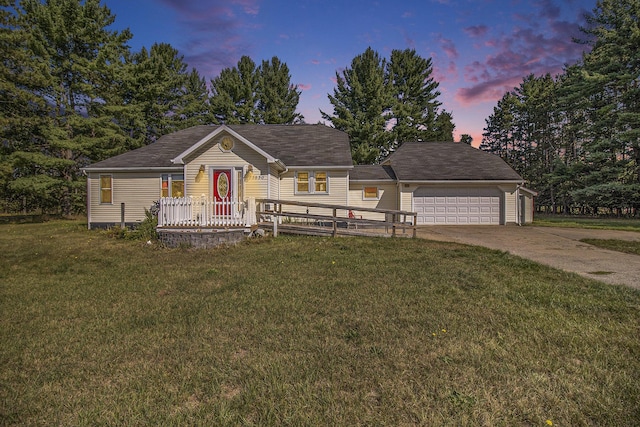 view of front of property featuring a garage, concrete driveway, and a front lawn