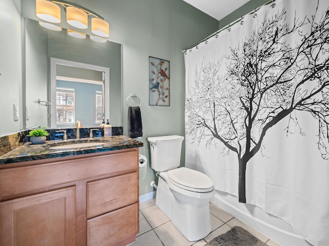 bathroom featuring tile patterned flooring, a shower with curtain, vanity, and toilet