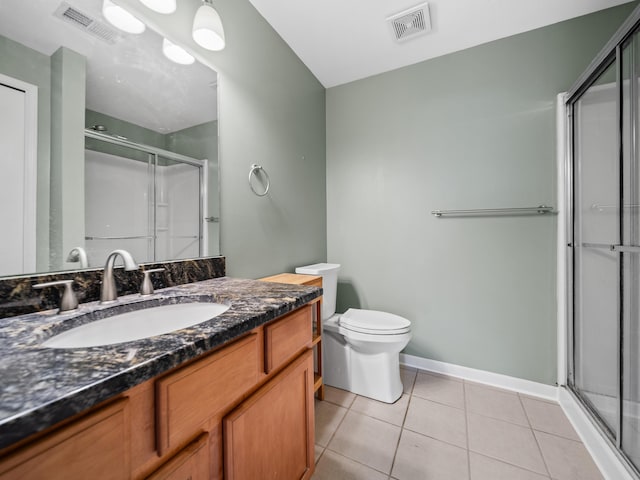 bathroom featuring tile patterned flooring, toilet, vanity, visible vents, and a stall shower