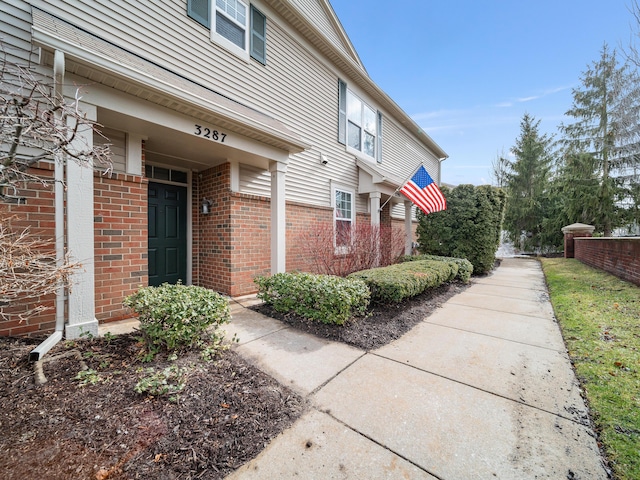 view of side of property with brick siding