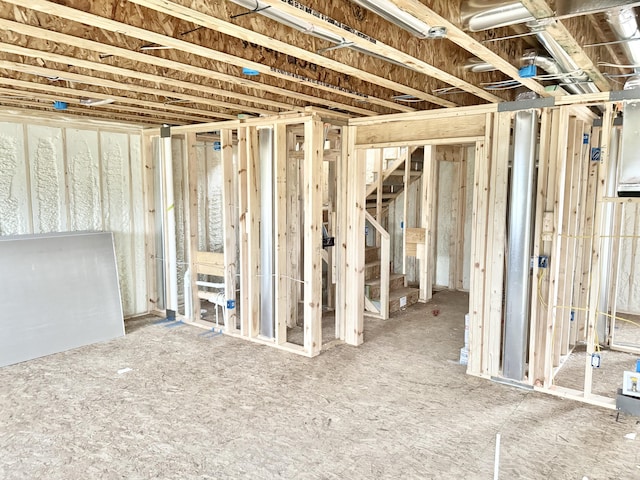 unfinished basement featuring stairs